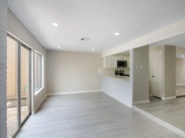 a view of kitchen with refrigerator and window