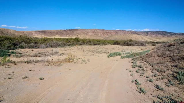 a view of ocean beach and mountain