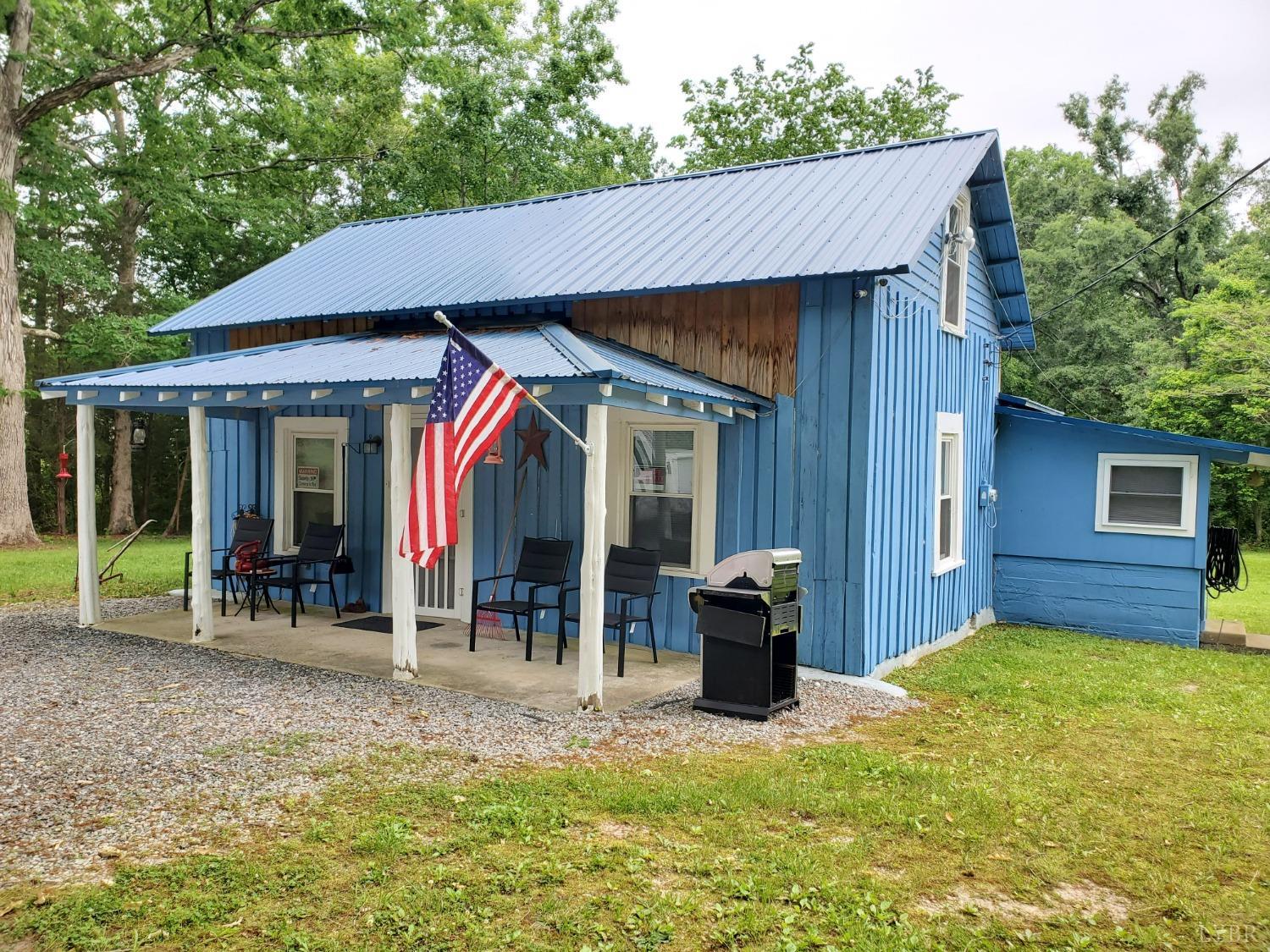 2237 Wards Corner Road Keysville, VA 23947 - Photo 1 of 20 a backyard of a house with yard and outdoor seating