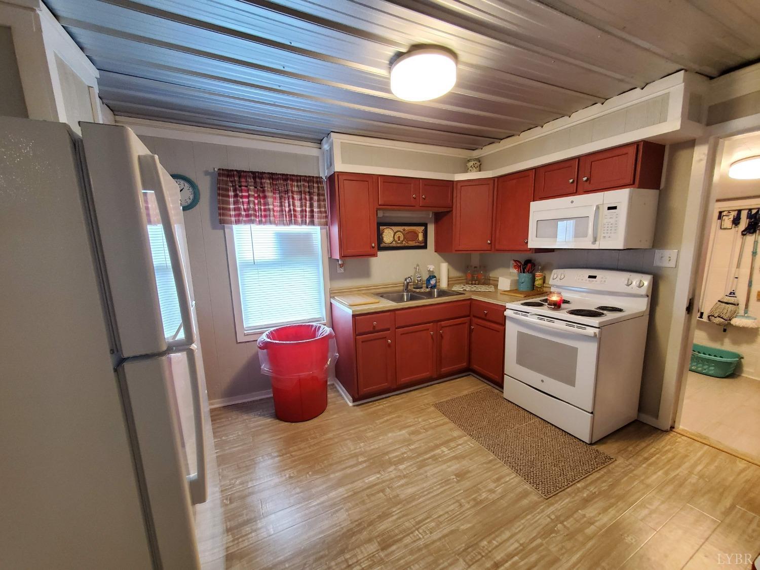 2237 Wards Corner Road Keysville, VA 23947 - Photo 12 of 20 a kitchen with a stove sink and a refrigerator