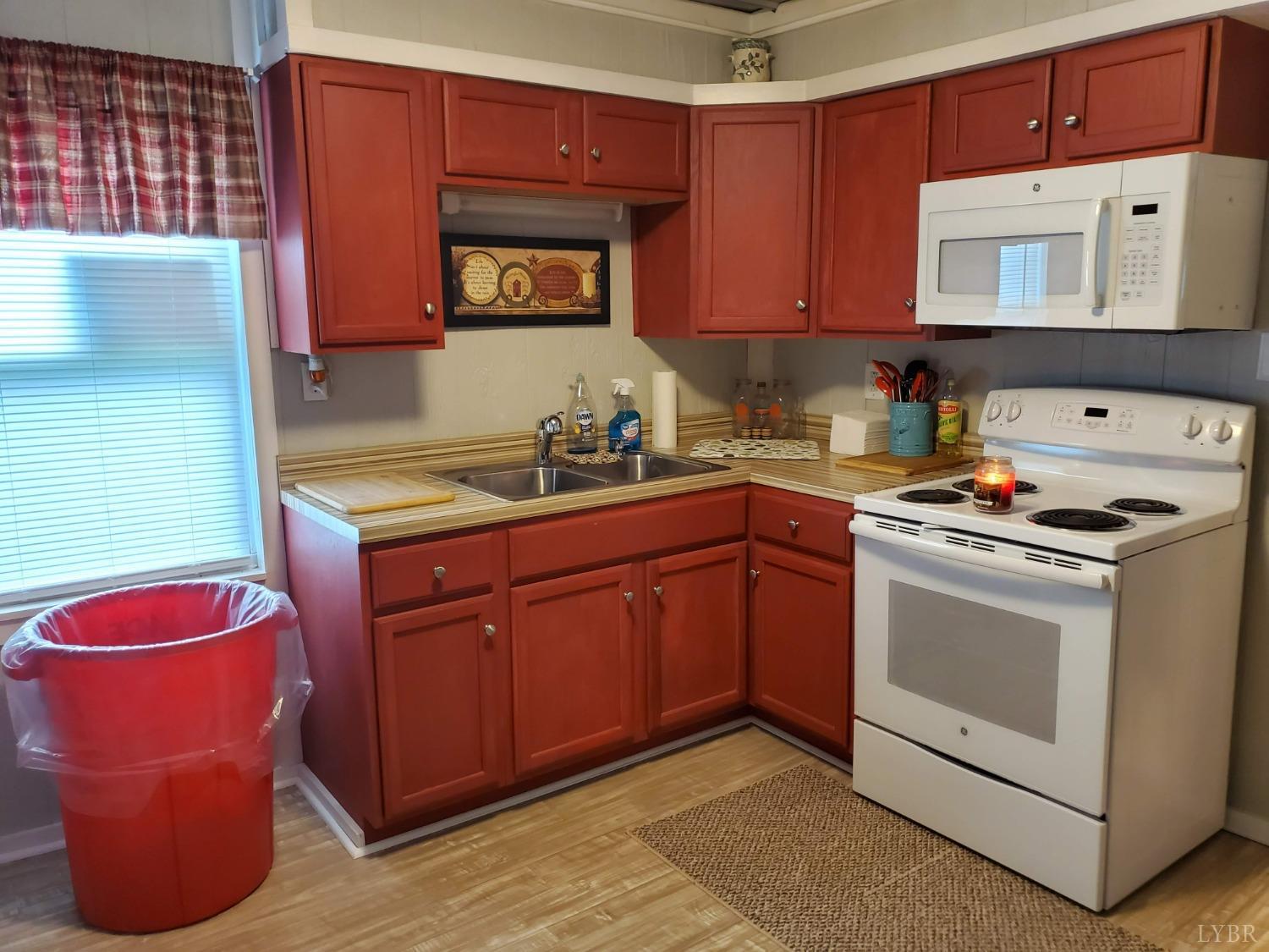 2237 Wards Corner Road Keysville, VA 23947 - Photo 13 of 20 a kitchen with stainless steel appliances granite countertop a stove a sink and a microwave