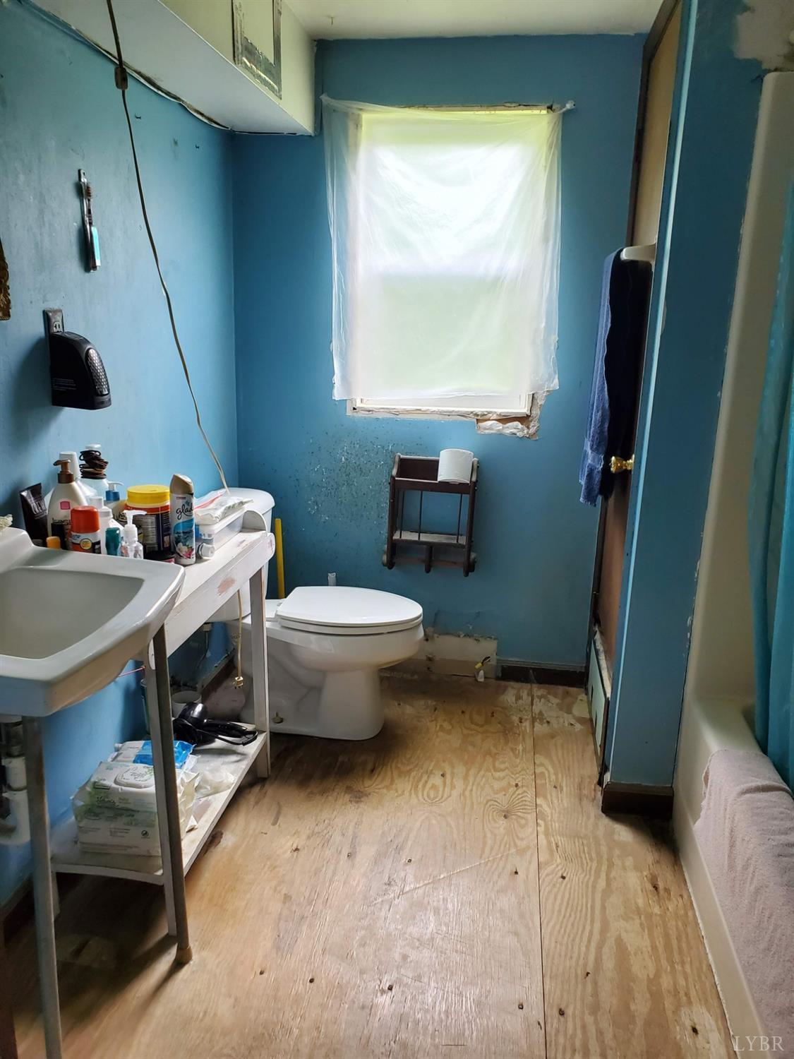 2237 Wards Corner Road Keysville, VA 23947 - Photo 17 of 20 a bathroom with a sink toilet and a window