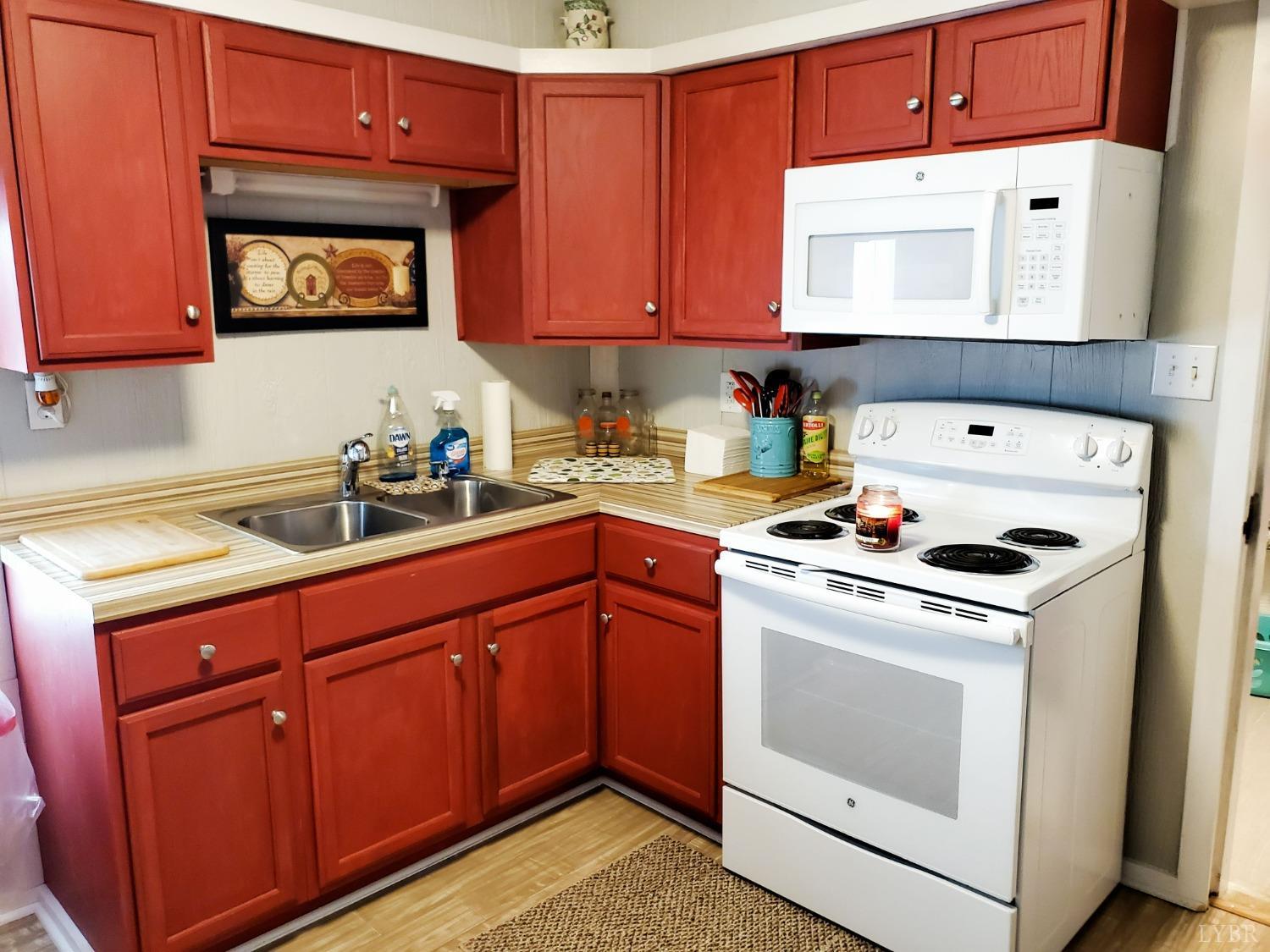 2237 Wards Corner Road Keysville, VA 23947 - Photo 20 of 20 a kitchen with stainless steel appliances granite countertop a stove a sink and a microwave