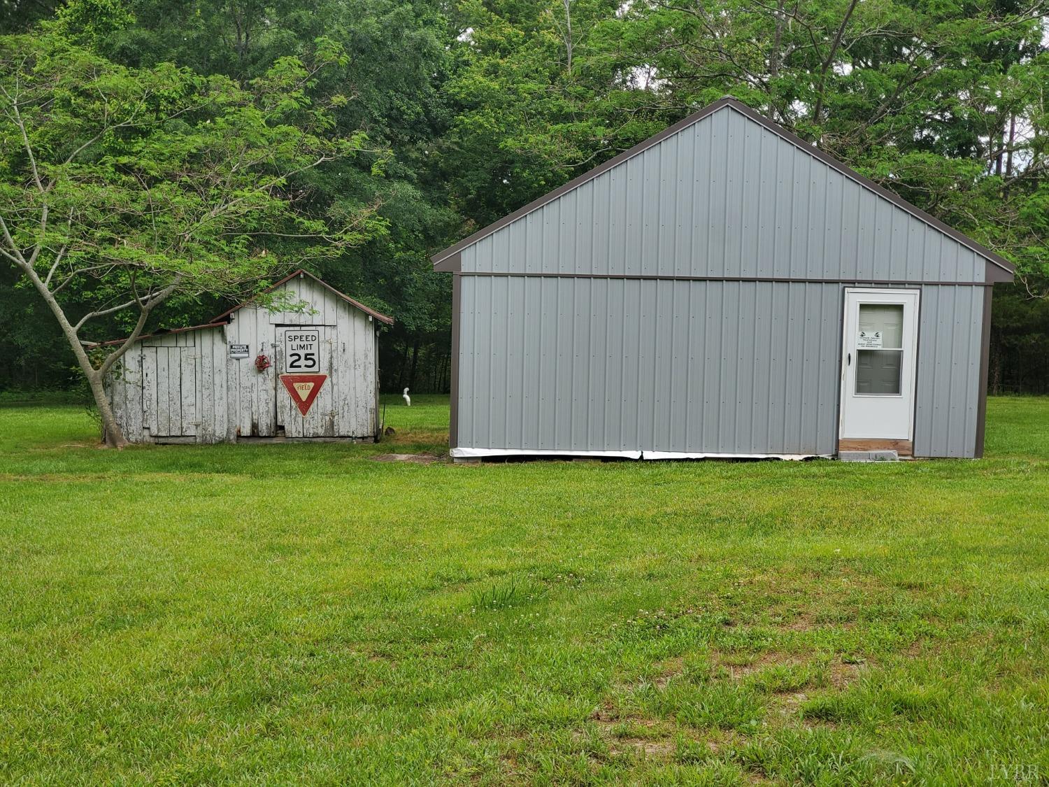 2237 Wards Corner Road Keysville, VA 23947 - Photo 4 of 20 a view of a backyard with potted plants and large tree