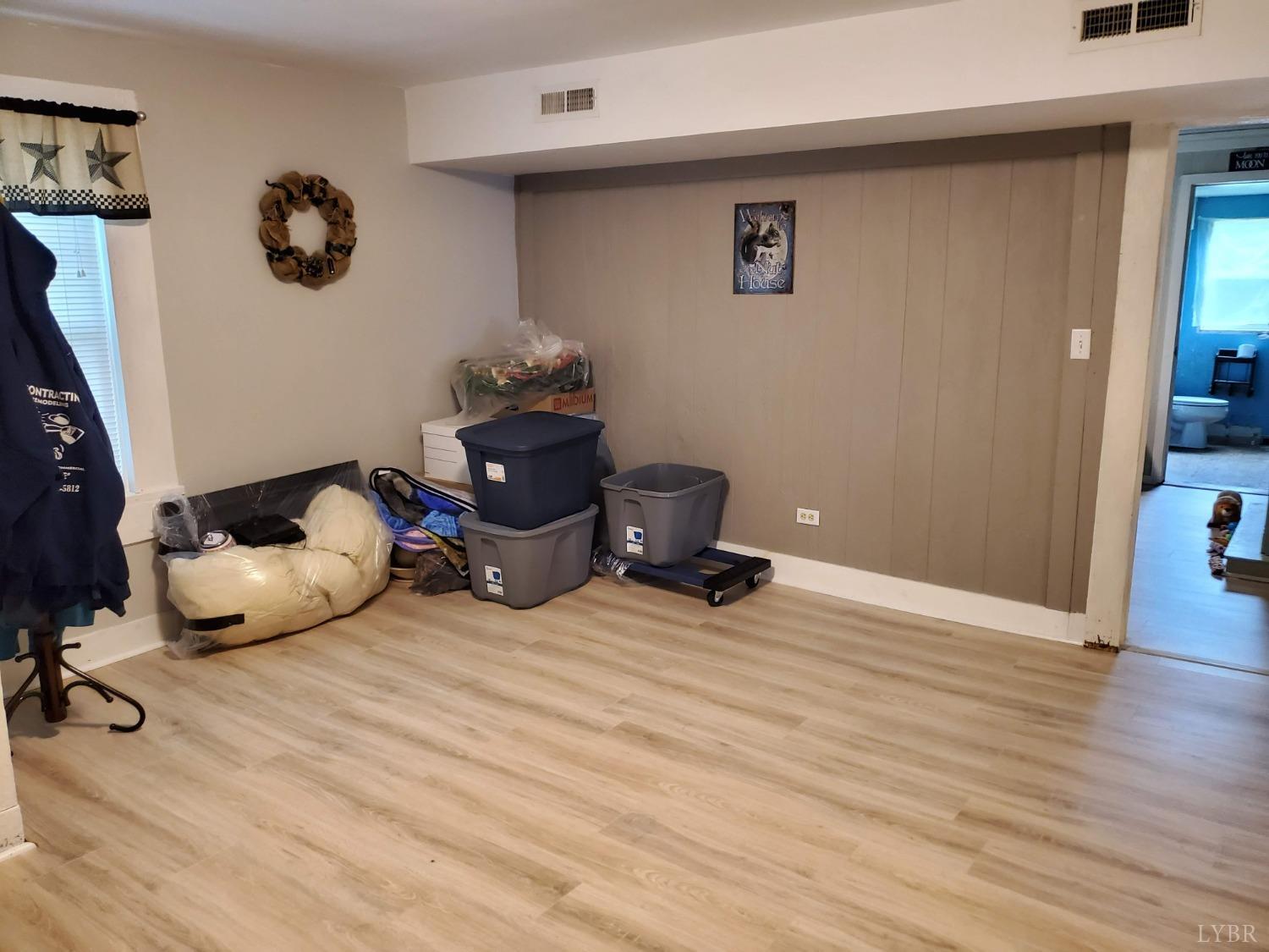 2237 Wards Corner Road Keysville, VA 23947 - Photo 7 of 20 a room with wooden floor and gym equipment