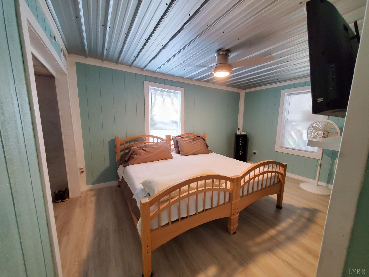 2237 Wards Corner Road Keysville, VA 23947 - Photo 9 of 20 a bedroom with a bed and a chandelier