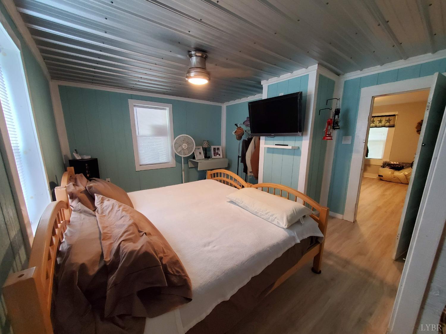 2237 Wards Corner Road Keysville, VA 23947 - Photo 10 of 20 a bedroom with a bed and a flat tv screen on dresser