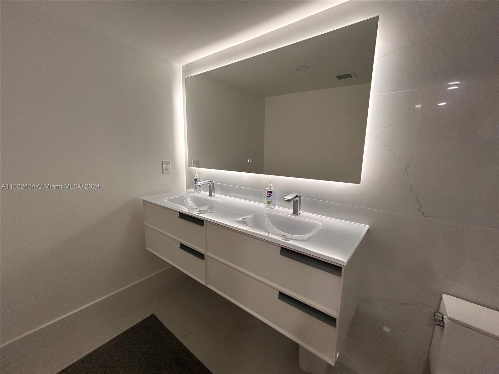 7601 East Treasure Drive, Unit PH206 North Bay Village, FL 33141 - Photo 16 of 24 a bathroom with a sink and a mirror