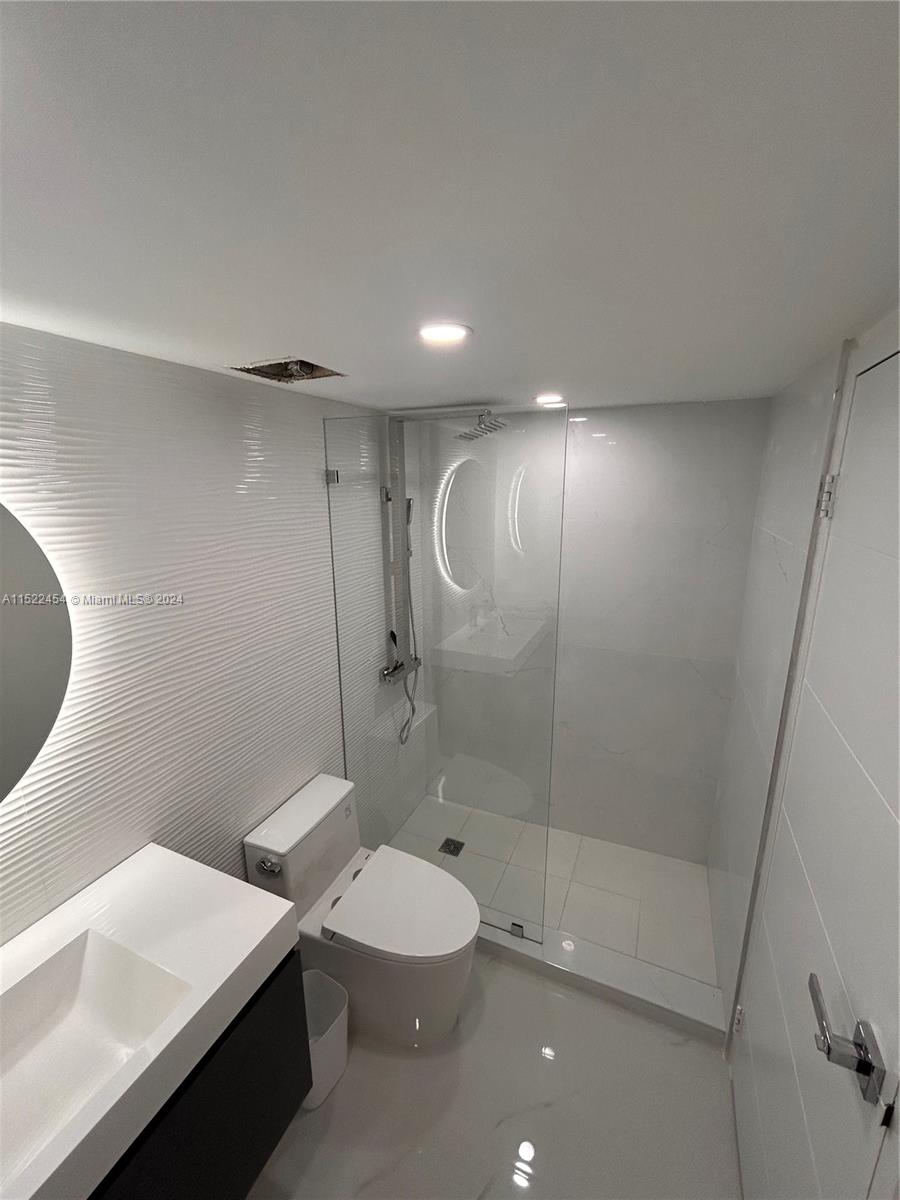 7601 East Treasure Drive, Unit PH206 North Bay Village, FL 33141 - Photo 20 of 24 a bathroom with a toilet a sink and shower