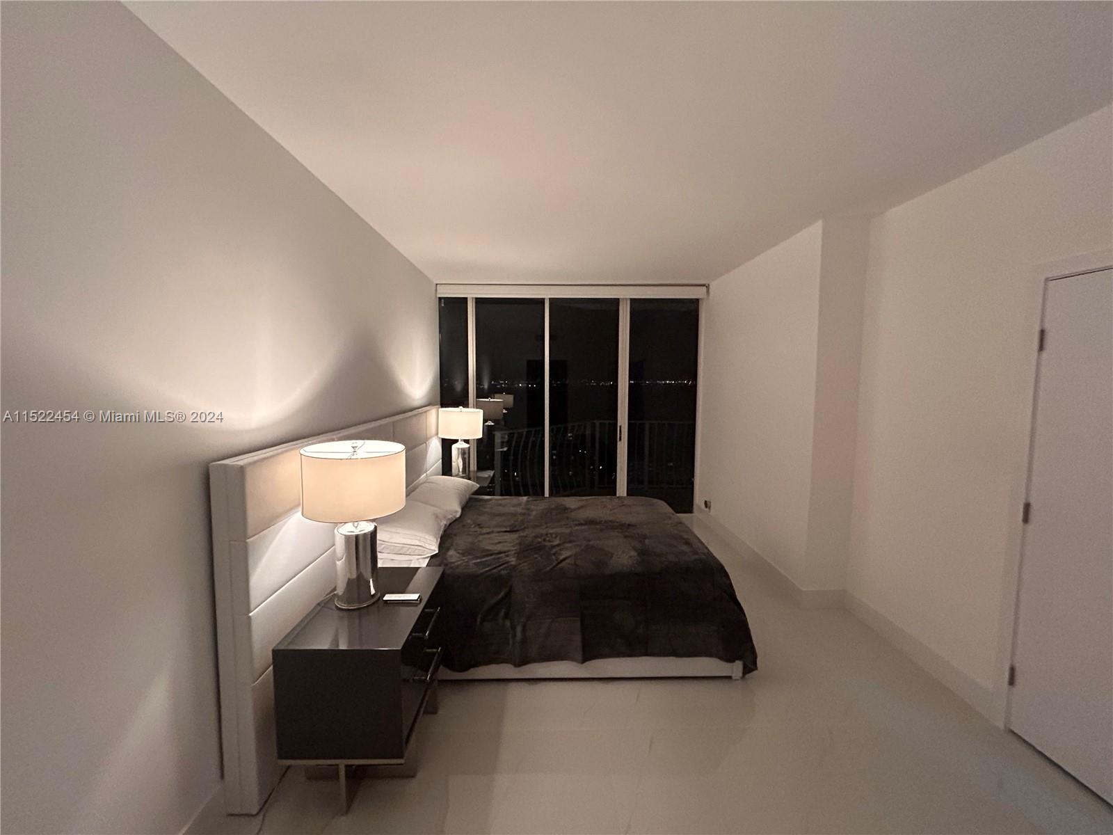 7601 East Treasure Drive, Unit PH206 North Bay Village, FL 33141 - Photo 21 of 24 a bedroom with a bed and a window