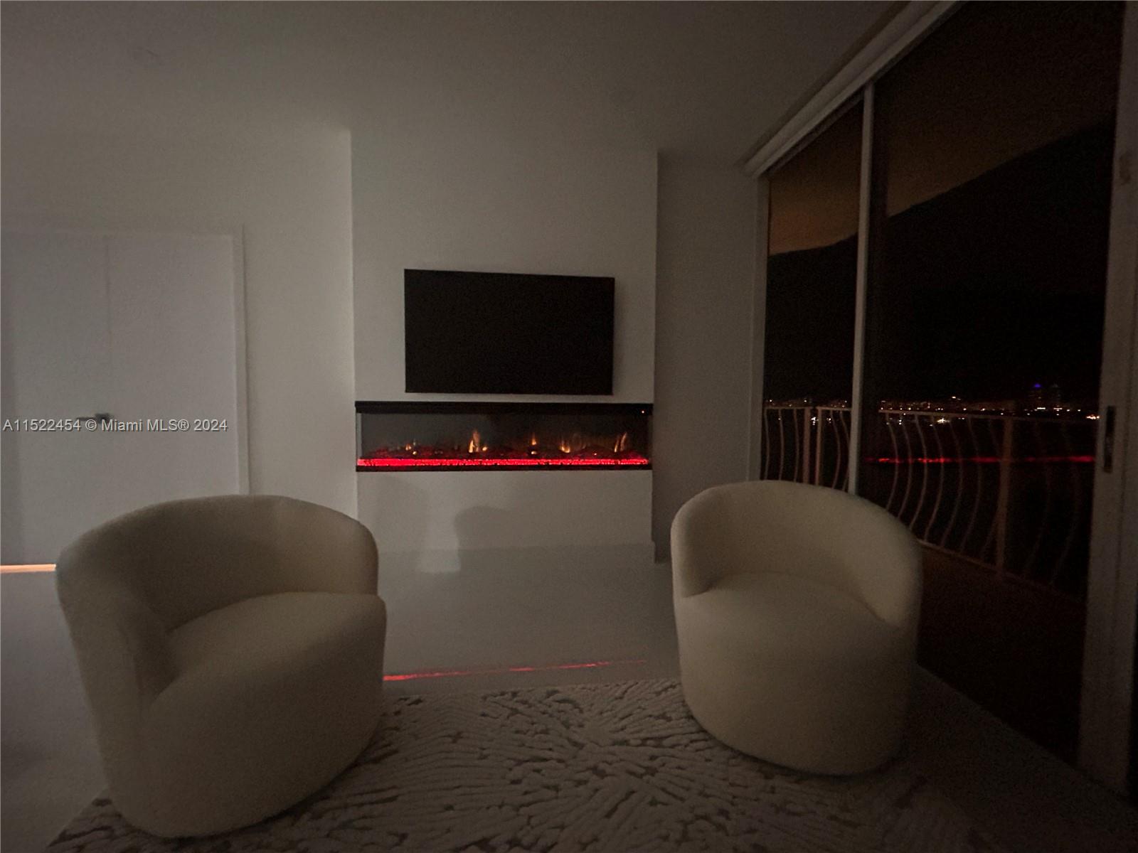 7601 East Treasure Drive, Unit PH206 North Bay Village, FL 33141 - Photo 23 of 24 a living room with furniture and a flat screen tv