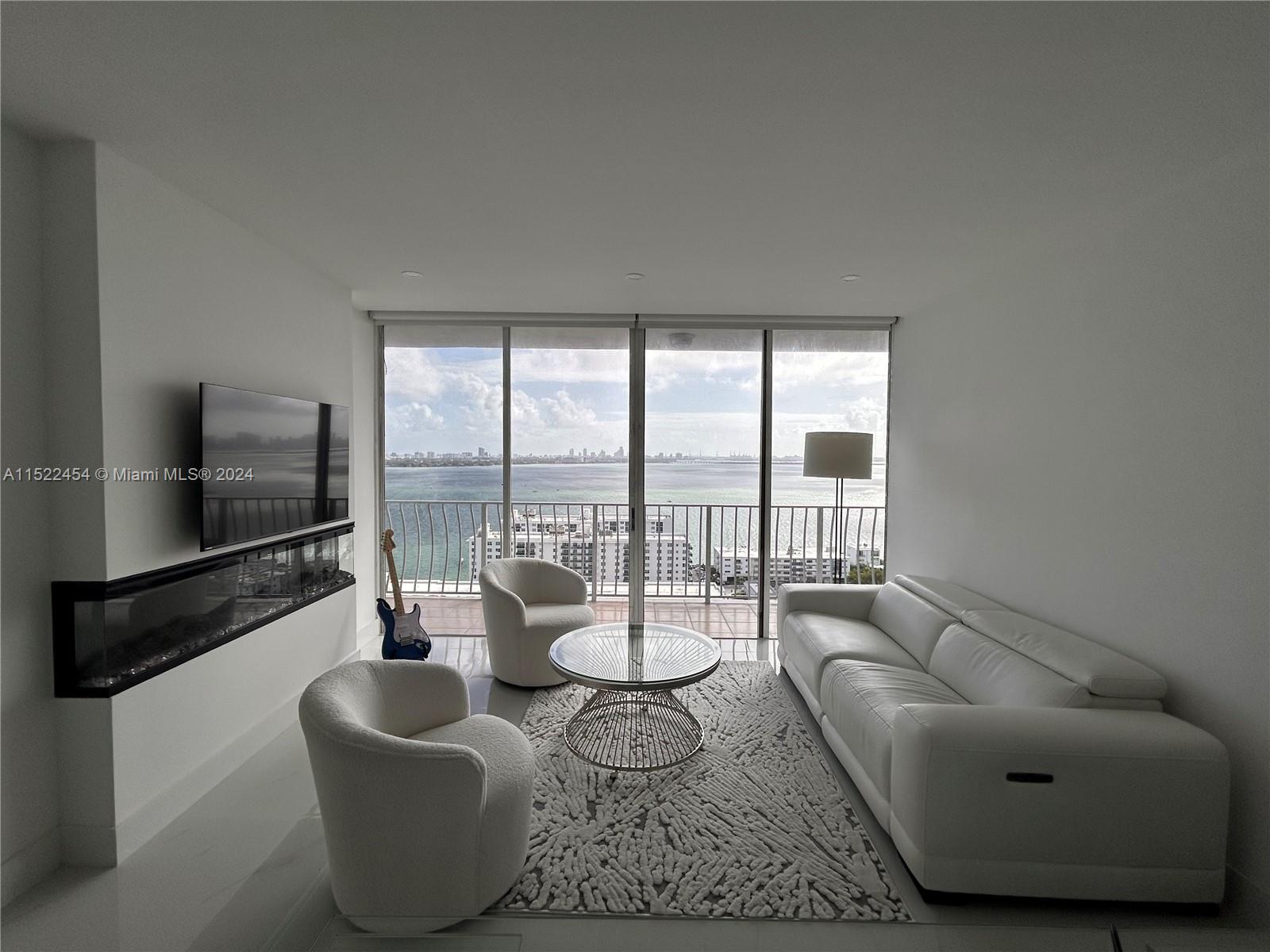 7601 East Treasure Drive, Unit PH206 North Bay Village, FL 33141 - Photo 9 of 24 a living room with furniture and a floor to ceiling window