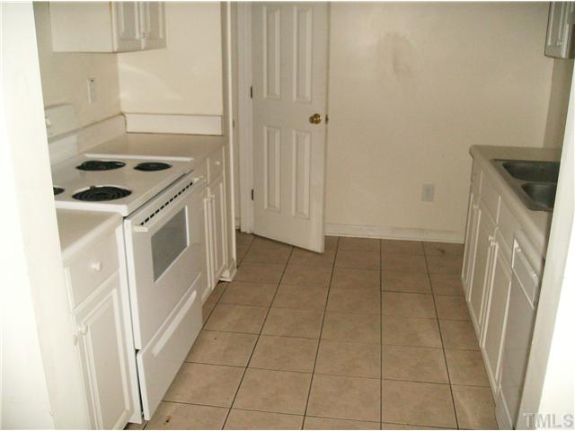1601 Rose Raleigh, NC 27610 - Photo 3 of 3 a kitchen with a stove top oven and cabinets