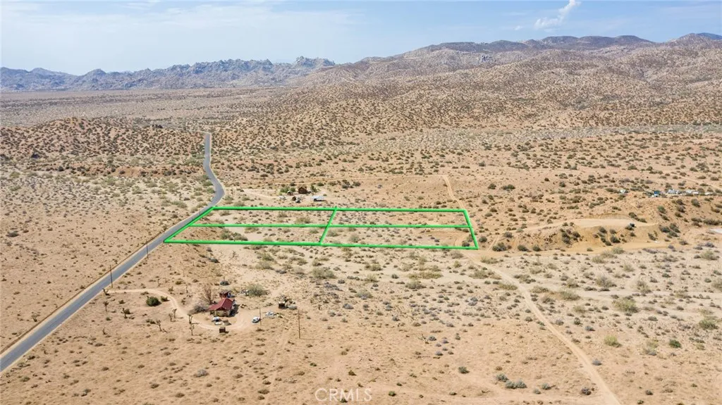 1000 Rimrock Road Pioneertown, CA 92268 - Photo 18 of 20 a view of a yard with a wooden bridge