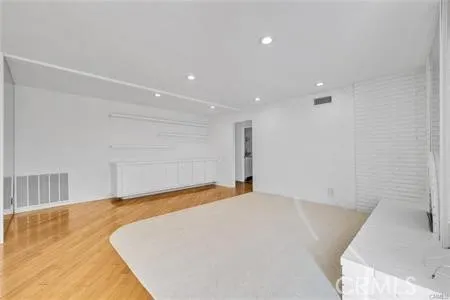 a view of a room with a white bed