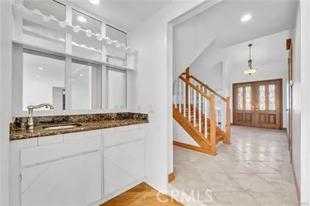 a view of a hallway with entryway and front door