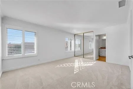 a view of a big room with windows and closet