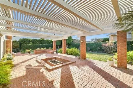 a view of a patio with a table and chairs next to a yard