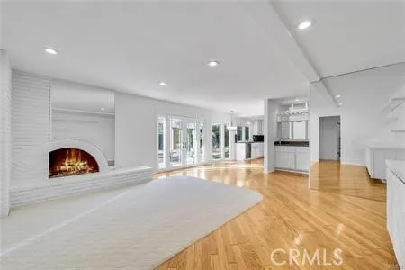 a living room with fireplace furniture and a wooden floor