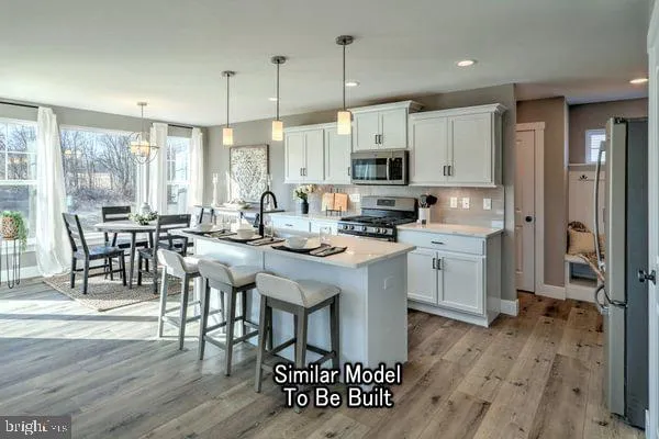 a open kitchen with sink cabinets and wooden floor