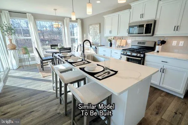 a kitchen with a dining table chairs and a refrigerator