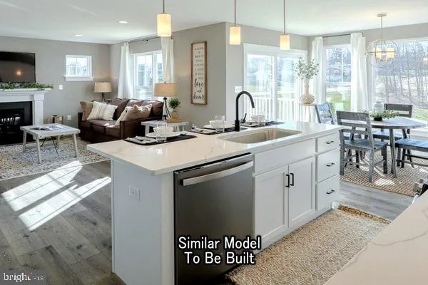 a kitchen with a sink stove and white cabinets