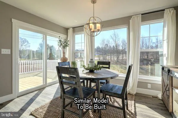 a view of a dining room with furniture wooden floor and a chandelier