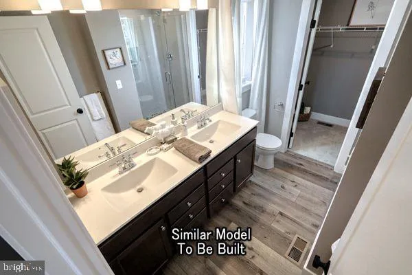 a bathroom with a sink a mirror and a shower