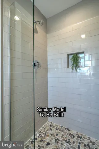 a bathroom with a shower and a sink