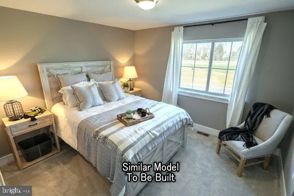 a bedroom with a bed and a chair