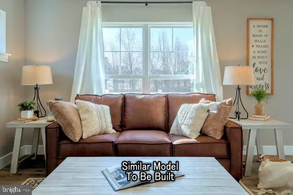 a living room with furniture a lamp and a window