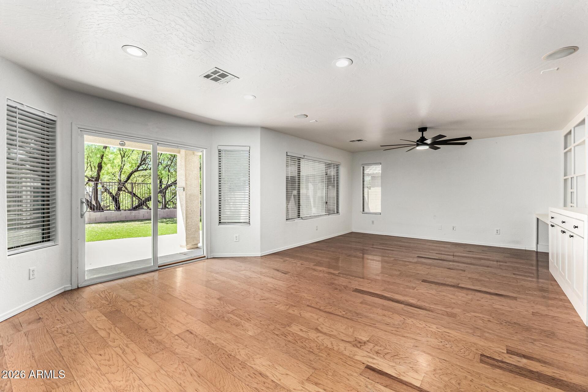 4208 South Sawmill Road Gilbert, AZ 85297 - Photo 9 of 46 a view of an empty room with a window and wooden floor