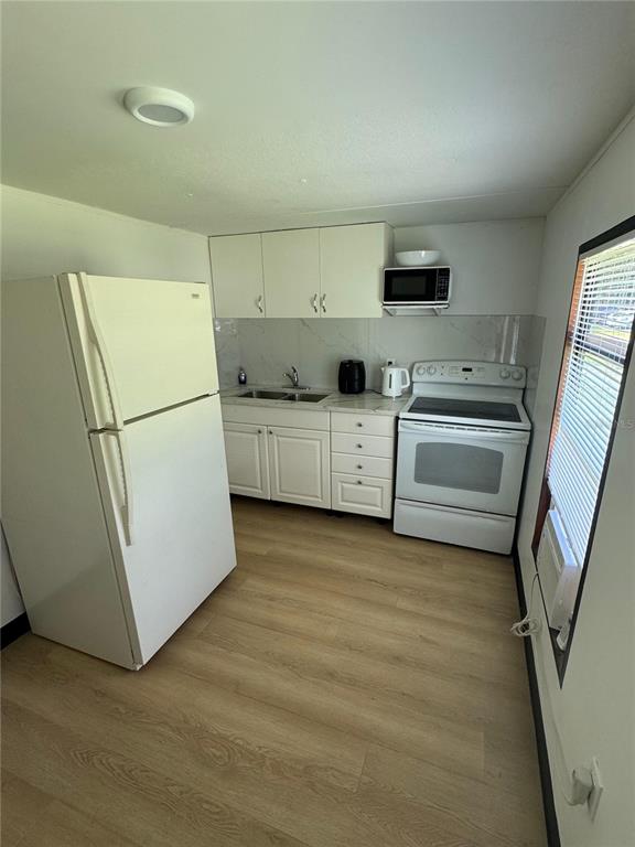 15482 Mapletree Drive Punta Gorda, FL 33955 - Photo 2 of 12 a kitchen with stainless steel appliances a refrigerator sink and stove