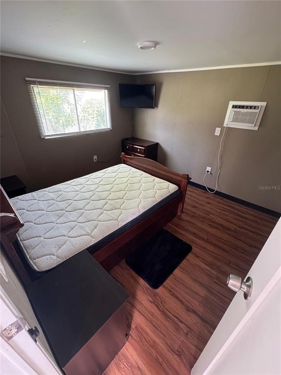 15482 Mapletree Drive Punta Gorda, FL 33955 - Photo 6 of 12 a bed sitting in a bedroom next to a window