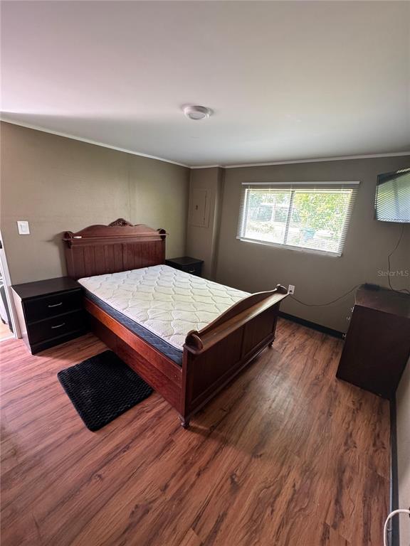 15482 Mapletree Drive Punta Gorda, FL 33955 - Photo 7 of 12 a bedroom with a bed and wooden floor