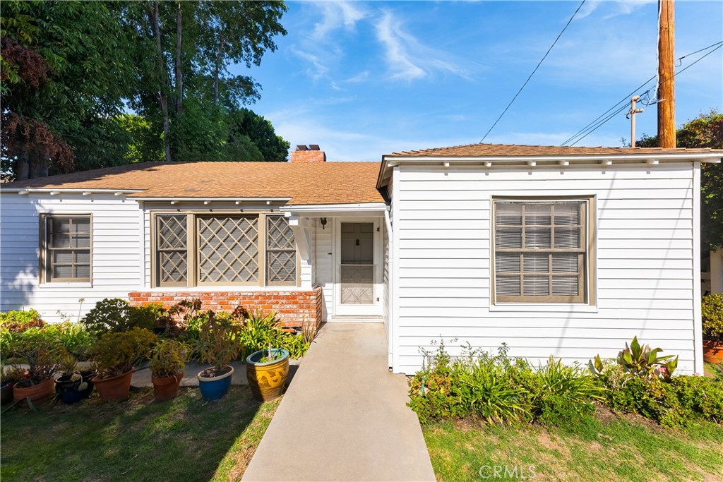 15207-15203 Greenleaf Street Sherman Oaks, CA 91403 - Photo 1 of 32 a front view of a house with a yard