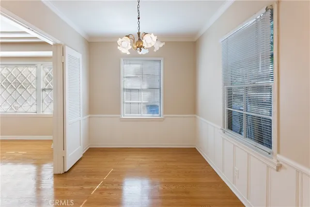 a view of a room with wooden floor and windows