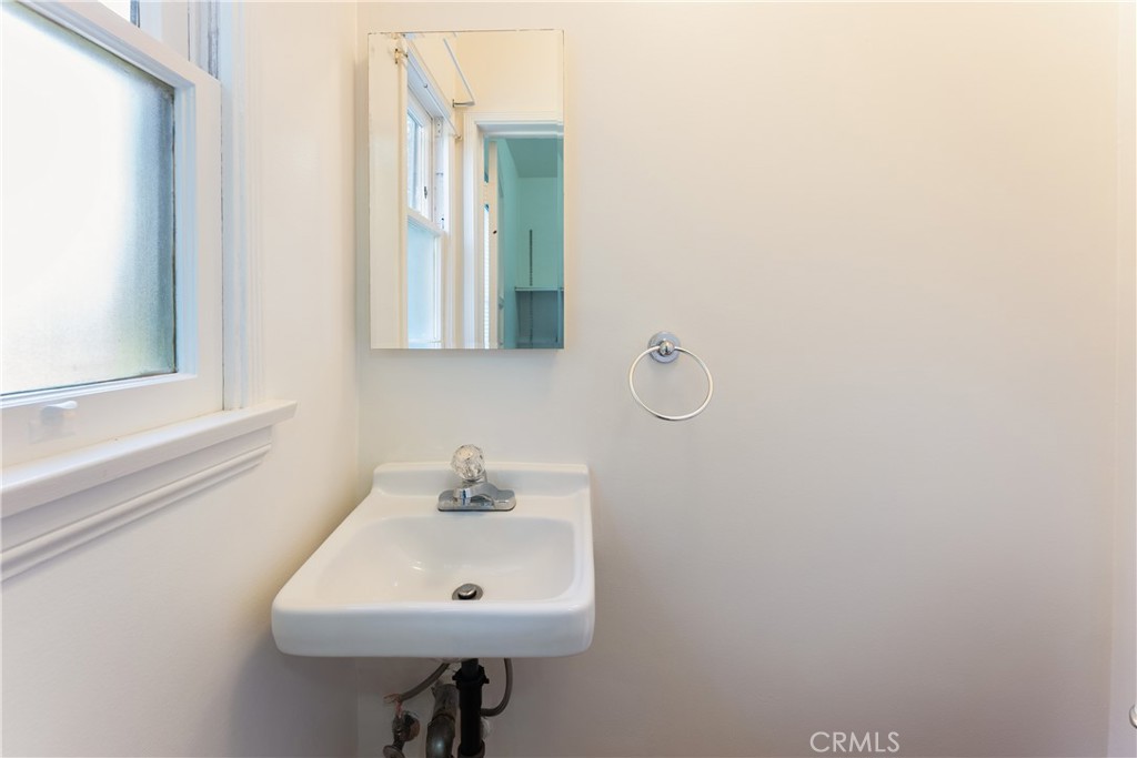 15207-15203 Greenleaf Street Sherman Oaks, CA 91403 - Photo 22 of 32 a bathroom with a sink a mirror and a window
