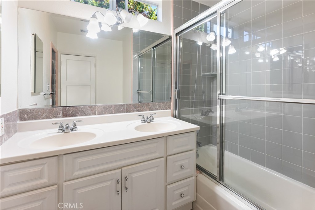 15207-15203 Greenleaf Street Sherman Oaks, CA 91403 - Photo 23 of 32 a bathroom with a sink shower and a mirror