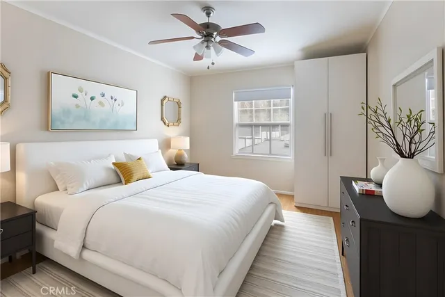 a bedroom with a large bed and a chandelier