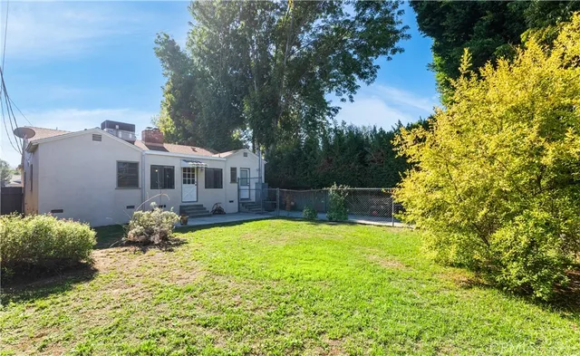 a backyard of a house with yard and outdoor seating