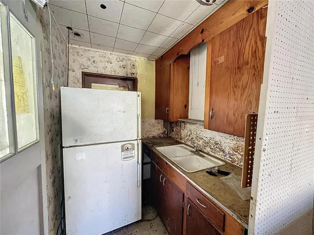 a white refrigerator freezer sitting inside of a kitchen