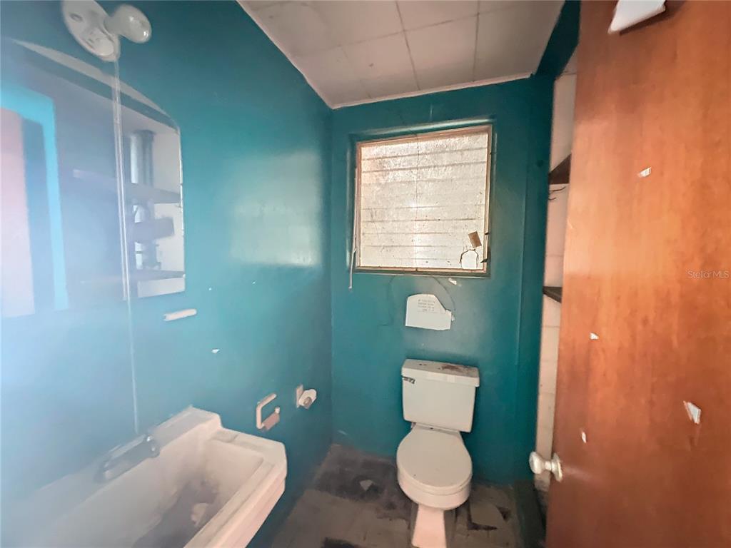 110 Reynolds Road Deleon Springs, FL 32130 - Photo 10 of 27 a bathroom with a toilet sink and mirror