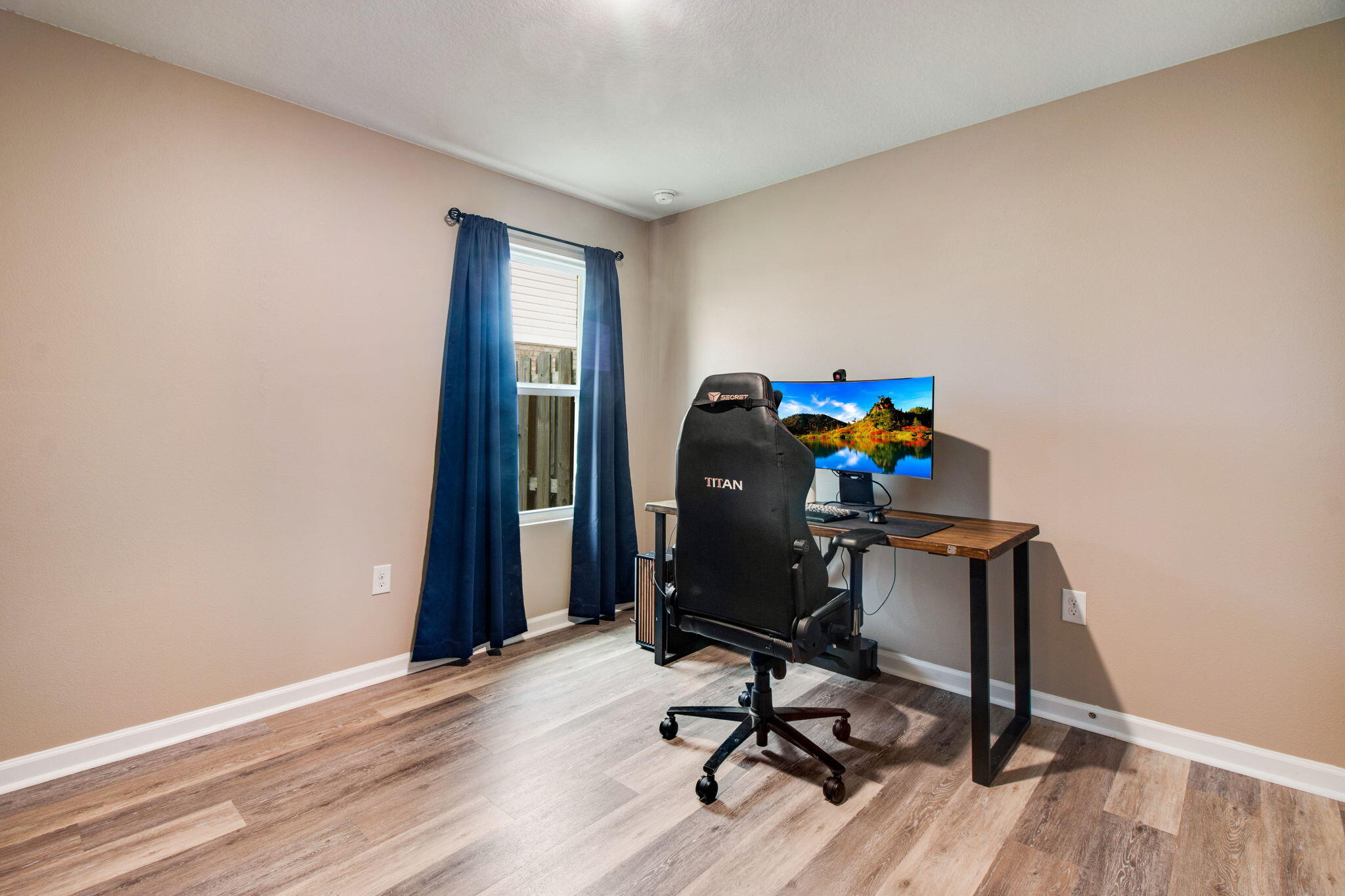 1032 Limpkin Street Crestview, FL 32539 - Photo 23 of 29 a view of a workspace with furniture and wooden floor