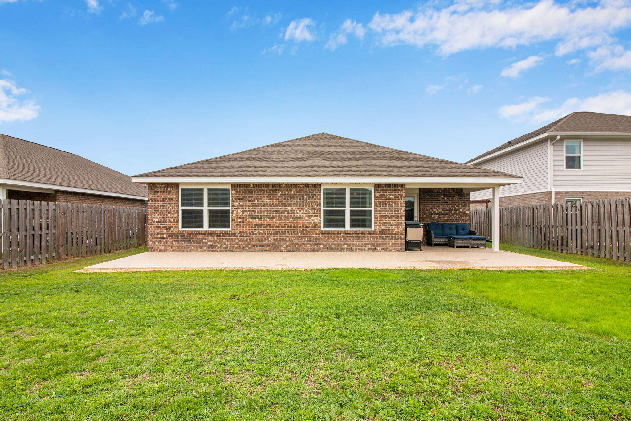 1032 Limpkin Street Crestview, FL 32539 - Photo 26 of 29 a front view of a house with a garden and porch