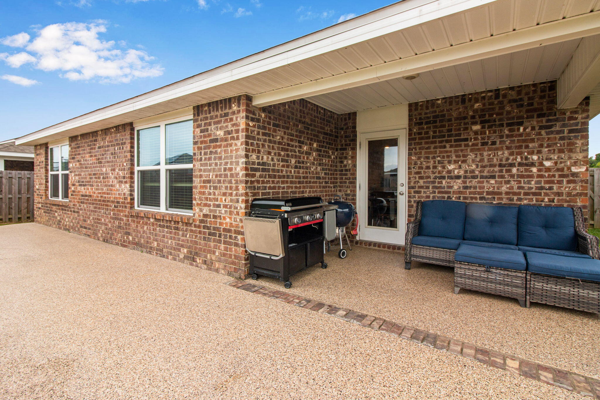 1032 Limpkin Street Crestview, FL 32539 - Photo 28 of 29 a backyard of a house with barbeque oven and outdoor seating