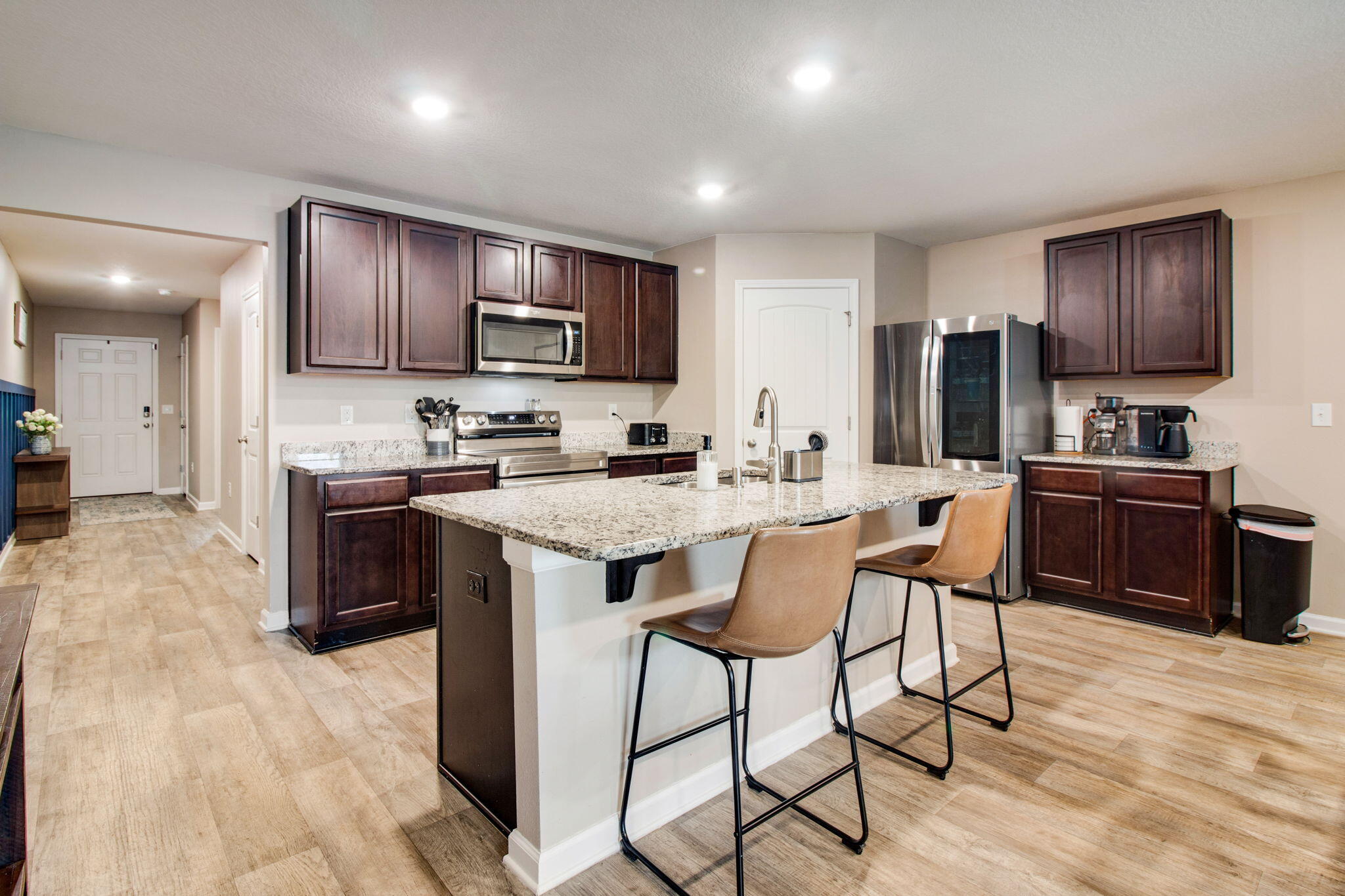 1032 Limpkin Street Crestview, FL 32539 - Photo 5 of 29 a kitchen with stainless steel appliances granite countertop a stove top oven a sink dishwasher a dining table and chairs