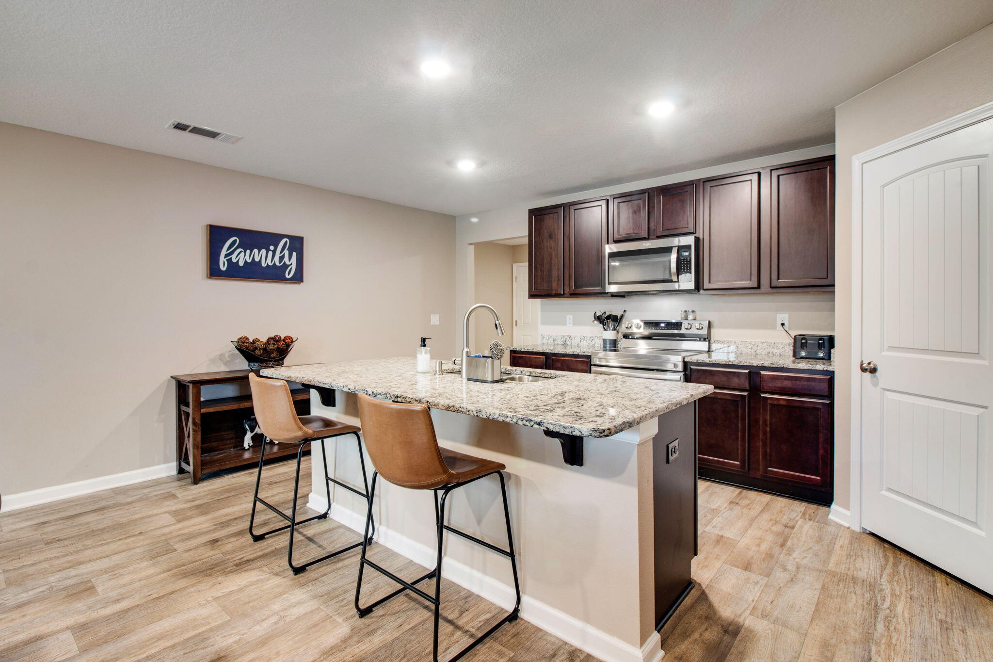 1032 Limpkin Street Crestview, FL 32539 - Photo 6 of 29 a kitchen with stainless steel appliances kitchen island granite countertop a sink and cabinets