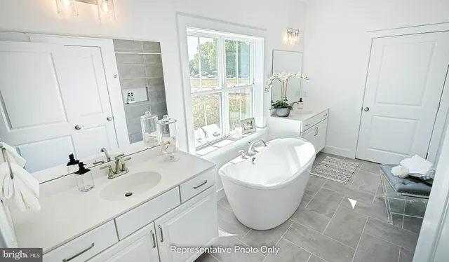 a spacious bathroom with a bathtub sink and toilet