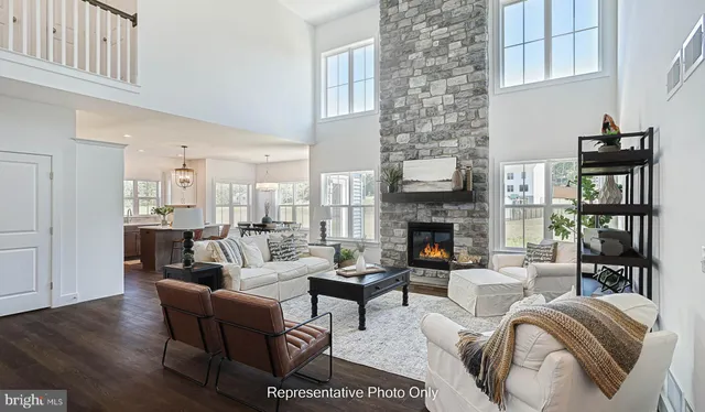 a living room with furniture large window and fireplace
